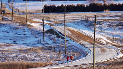 couple running on a dirt road in the countryside