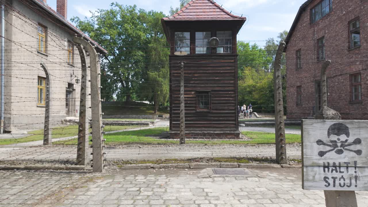 Guard tower and barbed wire fencing at Auschwitz concentration camp in Poland