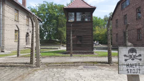 guard tower and barbed wire fencing at auschwitz concentration camp in poland