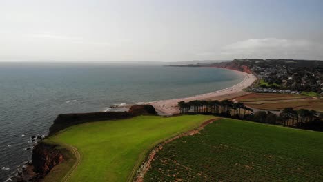 aerial over green landscape with budleigh salterton in the background