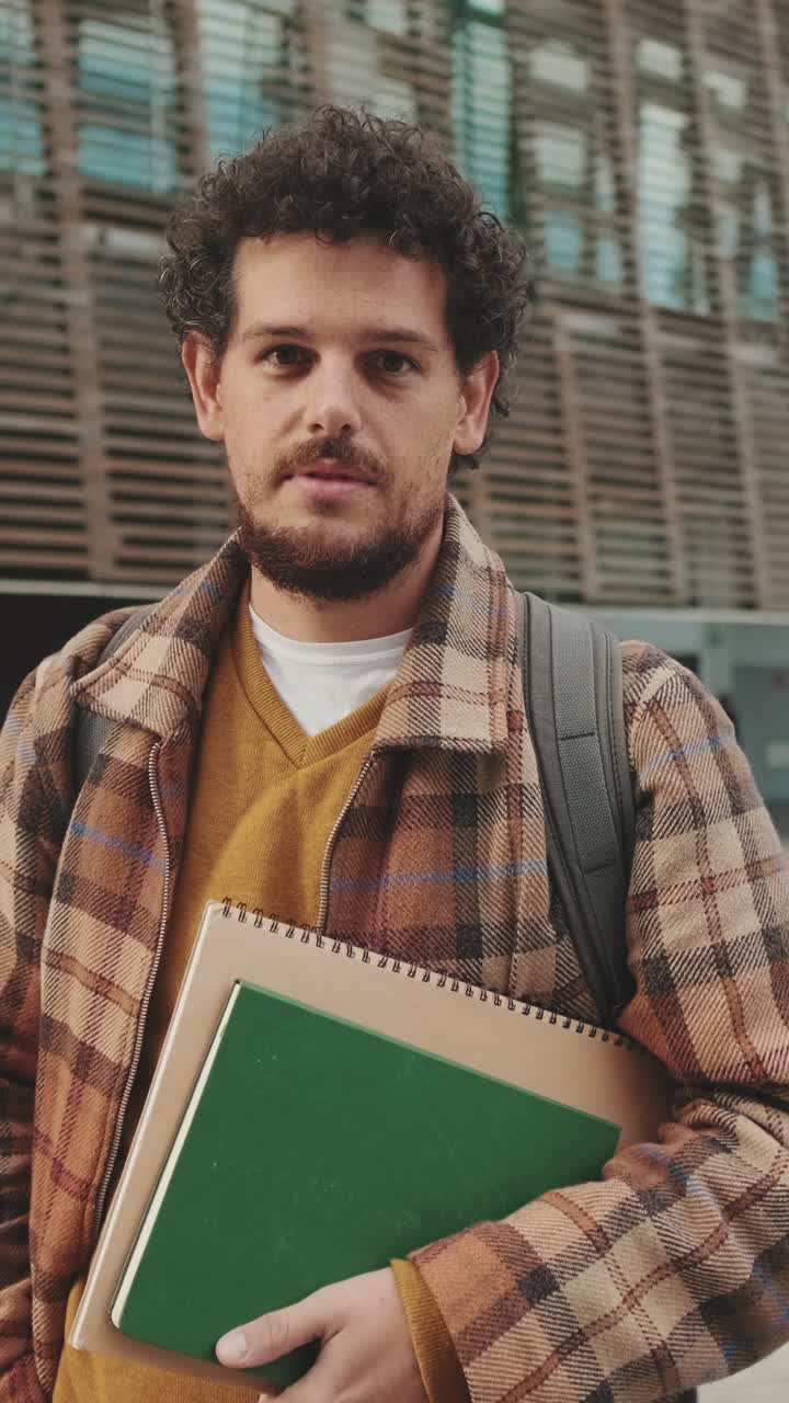 A man with notebooks and a backpack