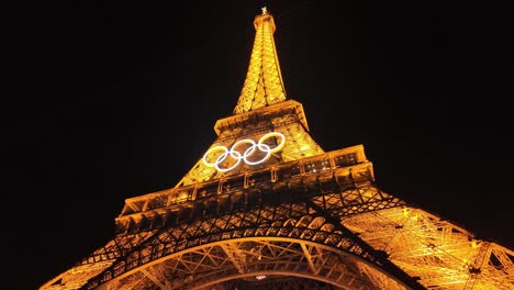 eiffel tower at night with olympic rings