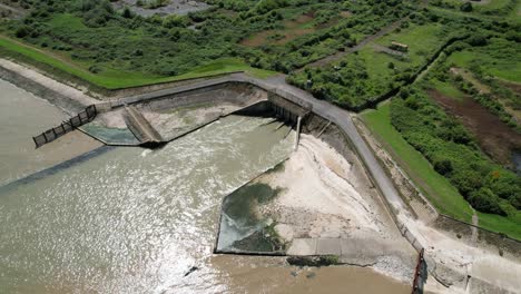 sewage outlet into river medway isle of grain kent uk drone aerial view