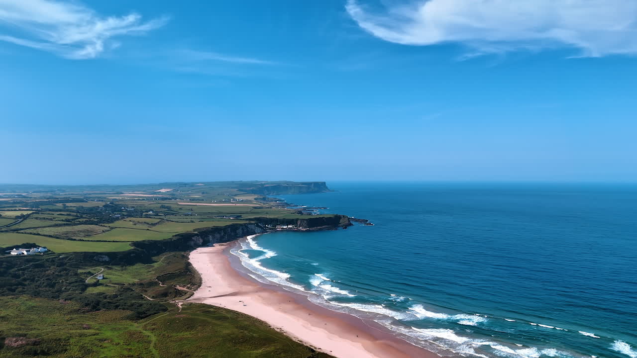 Blue ocean comes to the shore. Splendid scenery of the Pacific Ocean coastline with sandy beach. Ireland landscape. Aerial view.