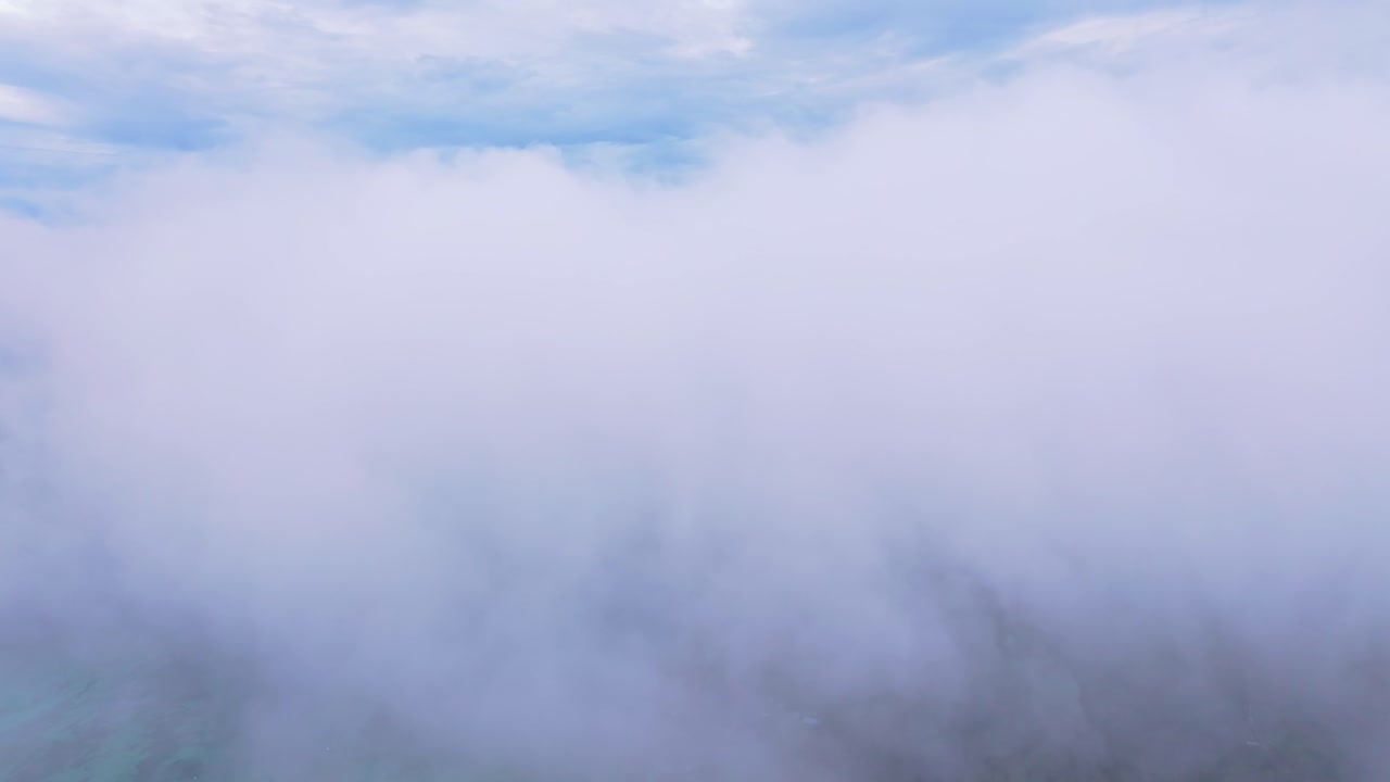 Misty clouds drift above lush Koh Phi Phi landscape, Thailand