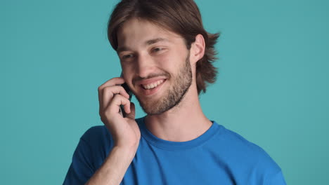 Caucasian-man-in-front-of-camera-on-blue-background.