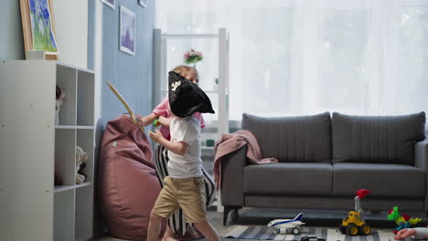 sister and brother play with swords laughing and shouting