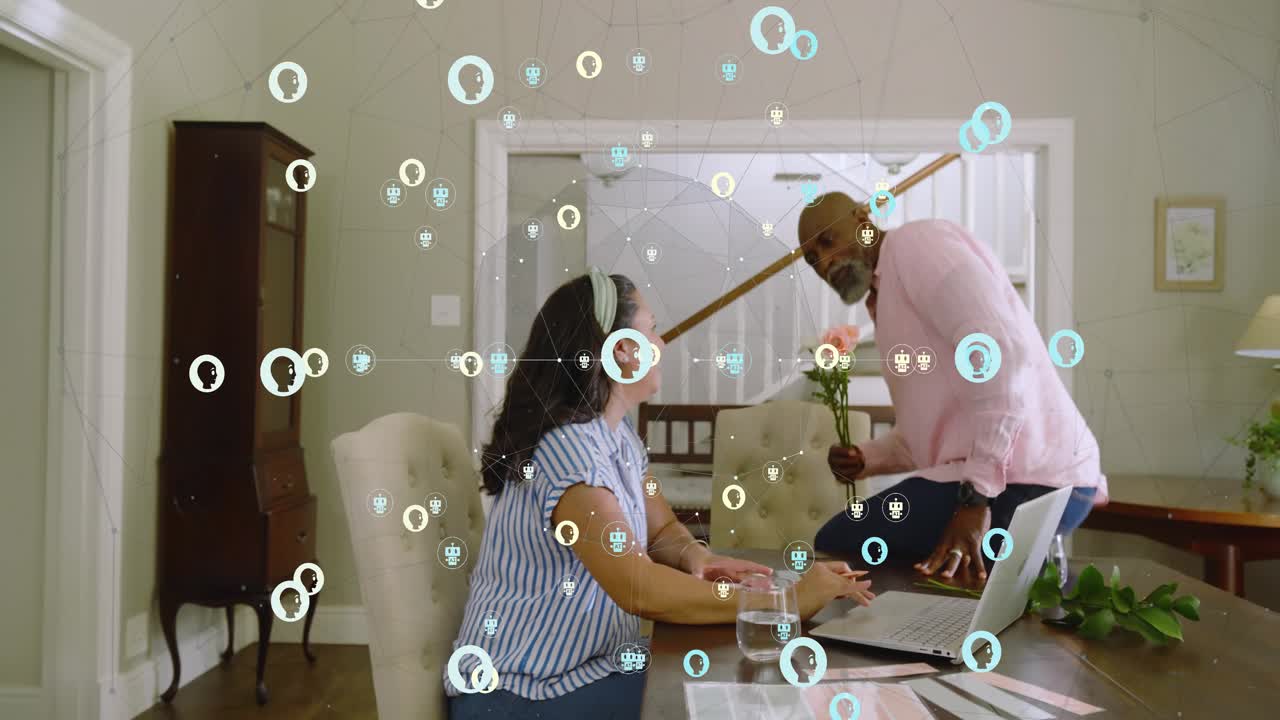 Woman typing laptop turning to man entering giving bouquet smiling as floating icons overlay work