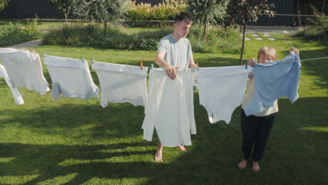 family drying laundry in the backyard