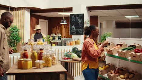 african american client putting organic produce in a paper bag