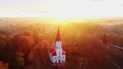 rucava evangelical lutheran church, drone of latvia's autumn beauty, sunrise, 4k