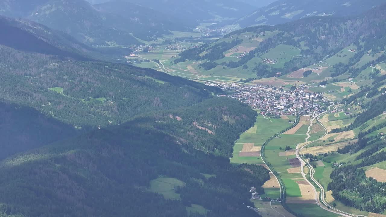 Aerial View Of Town in Valley Surrounded By Helm Monte Elmo Green Mountains in Italy, High Altitude View