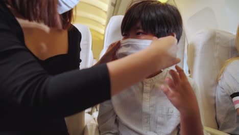 traveler wearing face mask while traveling on commercial airplane .