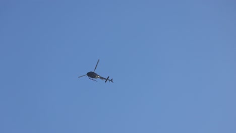 a helicopter flying slowly in the sky