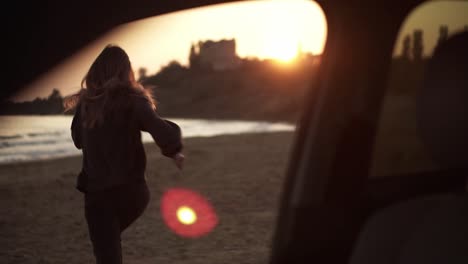 happy woman came to the sea, running out from the car seat to the beach