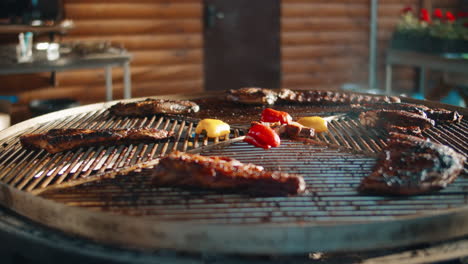 Juicy beef ribs grilling on spinning grill outdoor