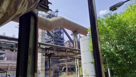 entangled steel pipes and old rusty lines in the factory premises of the landscape park in duisburg in germany