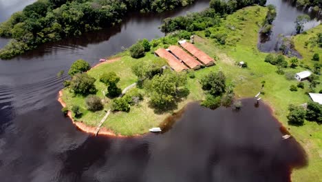 farm on small peninsula on the black river at amazon region