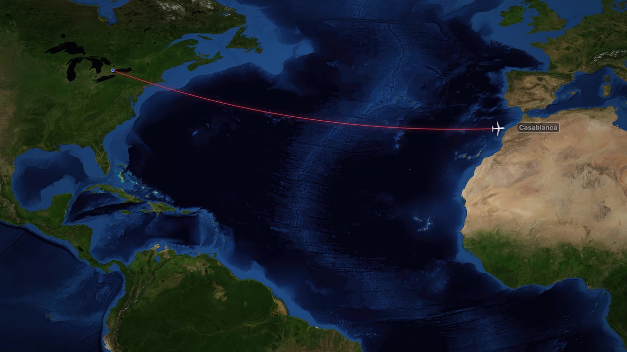 A commercial airplane icon travels across the Atlantic Ocean on a red line path