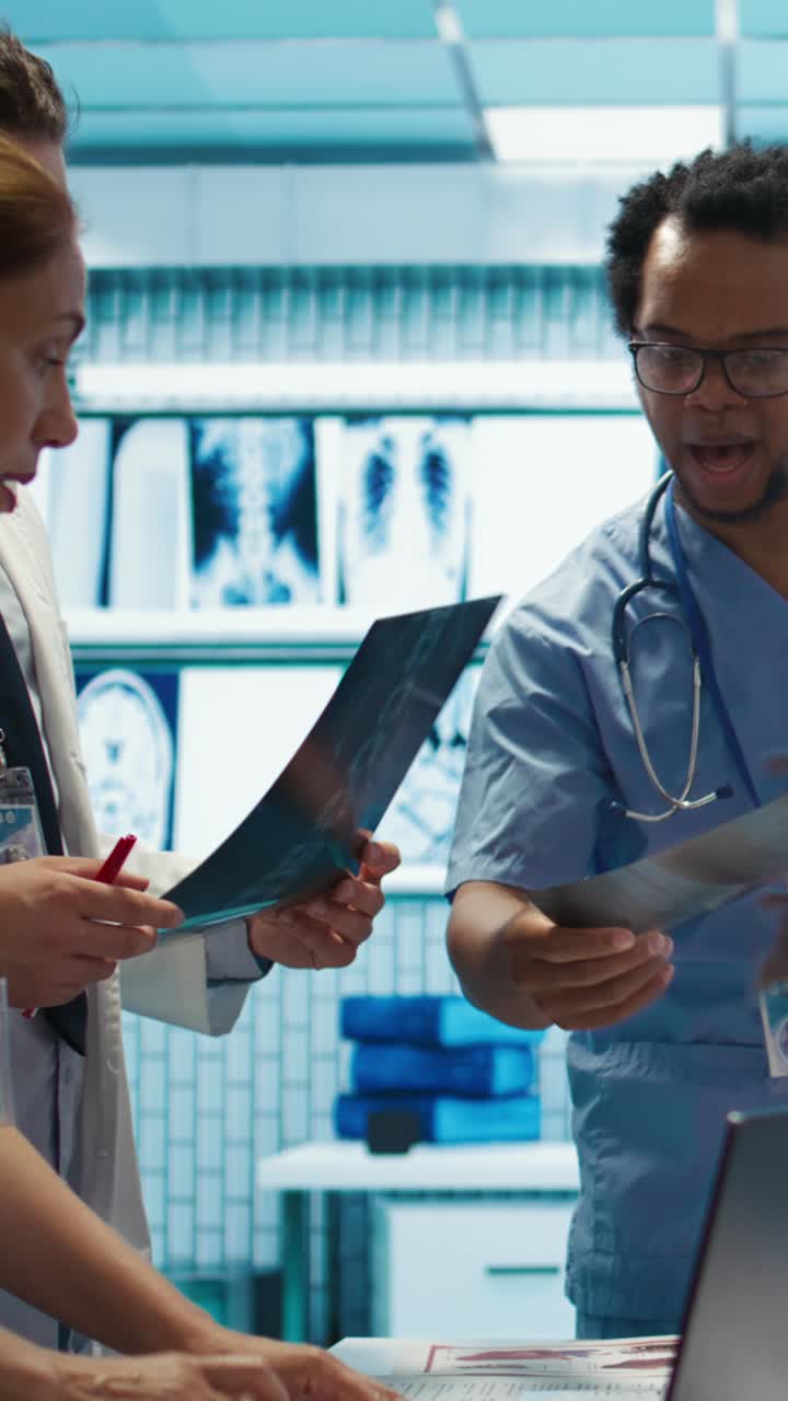 Vertical Video Physicians and radiologists analyzing x ray scans to create treatment plan