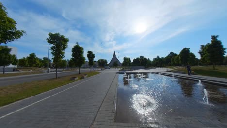 birds fly away from the city fountain