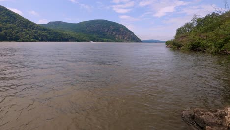 a summer time lapse of the hudson river in the hudson valley in new york state, with clouds moving overhead