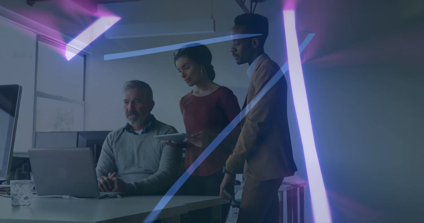 Woman showing tablet to senior on laptop, peer nodding for decision, business neon streaks crossing