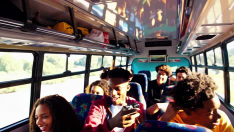 happy young friends traveling together on a bus