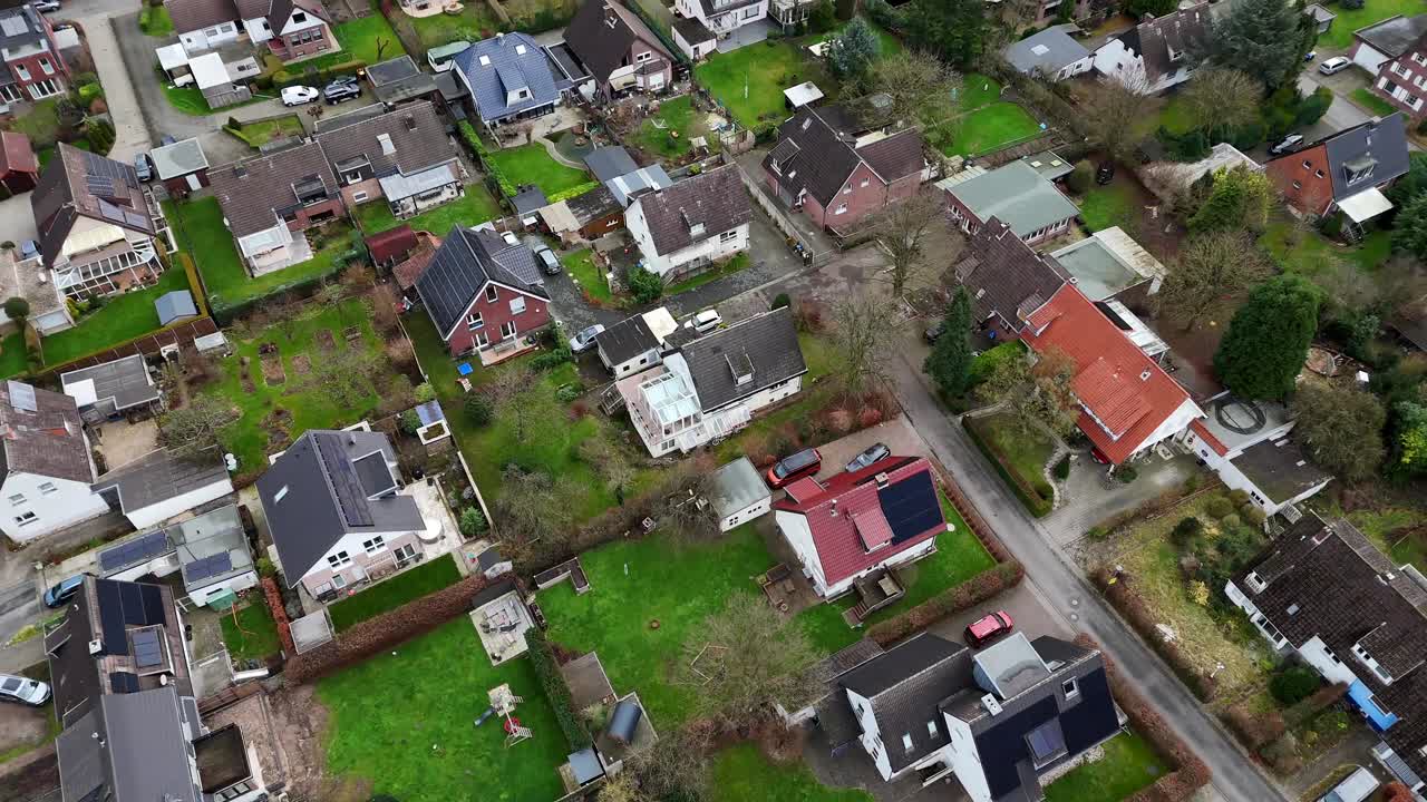 Single Family homes with solar panels on roof. American neighborhood in fall season. Aerial top down flyover shot. Modern Photovoltaic units on rooftop in USA.