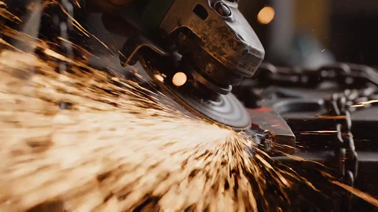 Angle Grinder Cutting Metal with Intense Sparks in Workshop