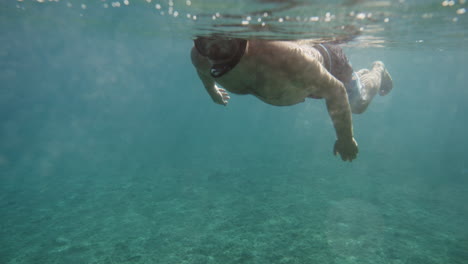 man snorkeling underwater