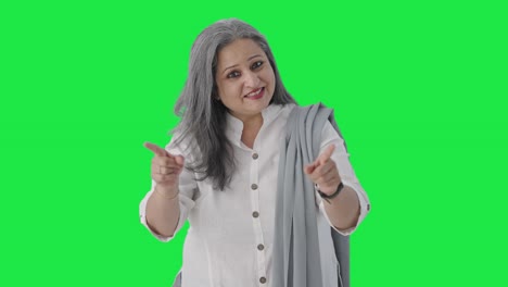 Happy-Indian-senior-businesswoman-talking-Green-screen