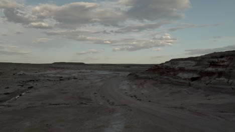 the barren cainsville desert landscape at sunset in southern utah - aerial flyover