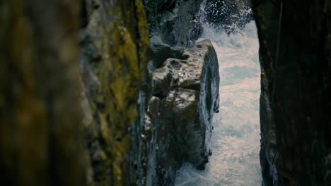 foamy sea streaming at rocks nature closeup. frothy water breaking at cliffside