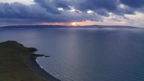 Aerial-Drone-sunset-flyover-coast-and-cliffs-near-Uig-Skye-Scotland-Autumn