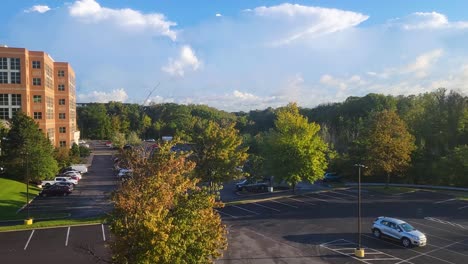 Timelapse-shot-of-parking-area-with-cars-and-people-moving-around-on-a-cloudy-sunset