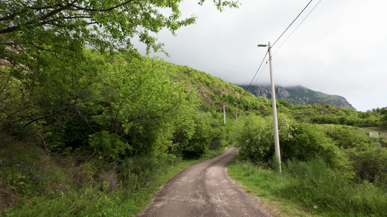 Driving view lush green areas of Montengro Budva Kotor mountainous region