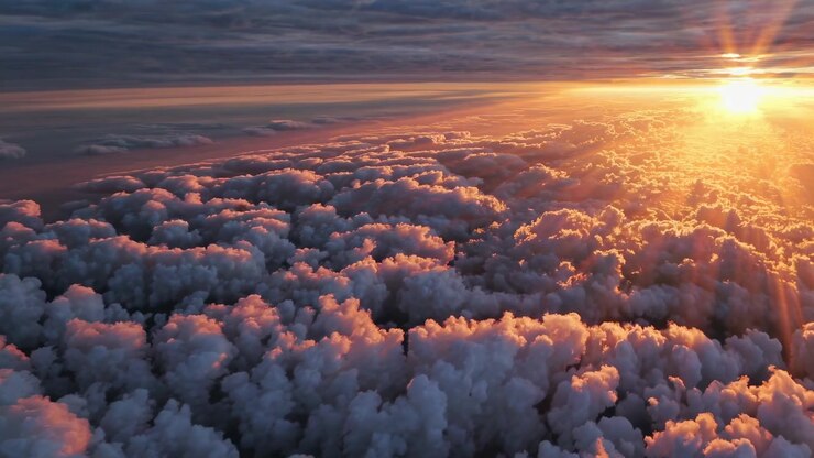 Majestic Aerial View of Golden Sunset Above Clouds