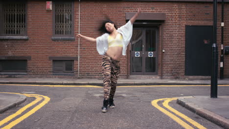 Contemporary-funky-asian-woman-street-dancer-dancing-freestyle-in-the-city