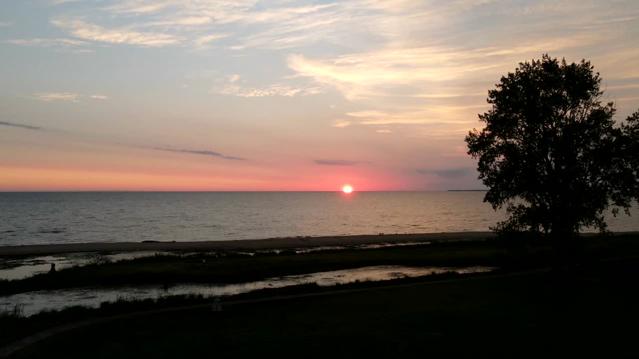 4k drone video time lapse of sunrise over Lake Huron in Bay City, Michigan.