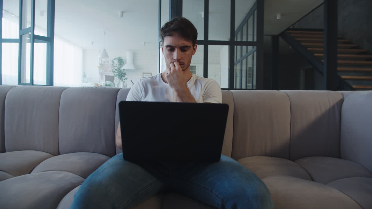 Focused man working on computer at home