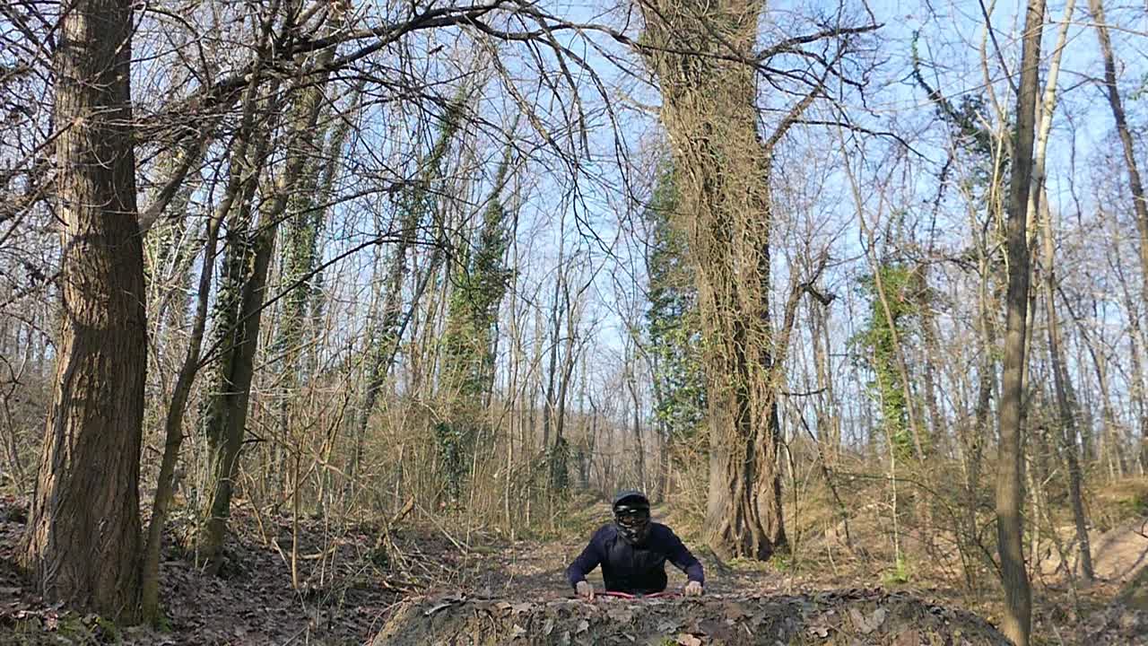 MTB rider jumping above the camera, tracking shot