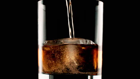 pouring cola over ice