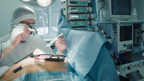 doctor with laser scalpel operates heart in clinic. cardiology specialist works with patient ill organ during coronary artery bypass surgery in hospital