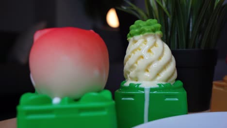 Close-up of pineapple swirl ice cream dripping with peach-shaped dessert beside it. Ideal for food ads, dessert reels, ASMR, and eye-catching summer visuals.