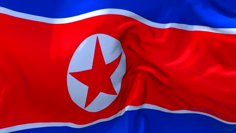 la bandera de corea del norte ondeando en el viento animación en cámara lenta. 4k textura de tela realista bandera soplando suavemente en un día de viento fondo de bucle continuo sin costuras.