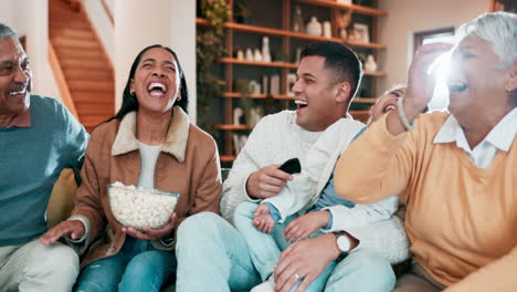 family, laugh and popcorn on sofa for movie