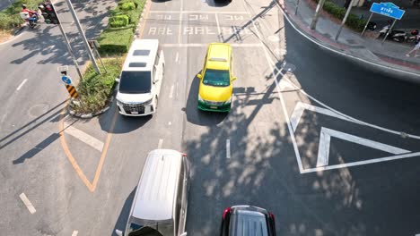 vehicles navigate through a bustling city crossroad.