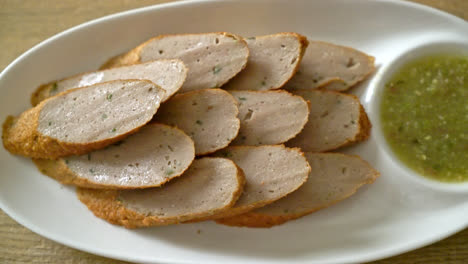 fried chinese fish cake or fish ball line sliced with spicy seafood dipping sauce