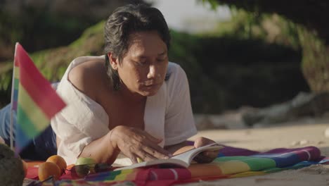 man reading on beach